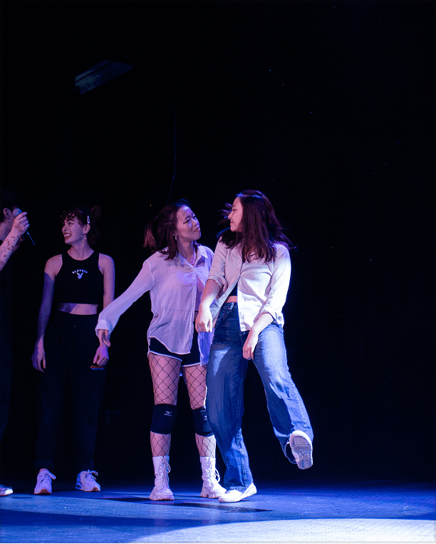 Performers on stage with floor lighting